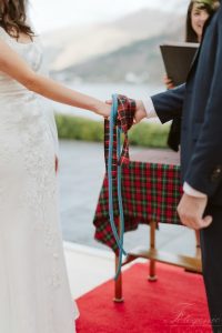 woman in white dress holding hands with man