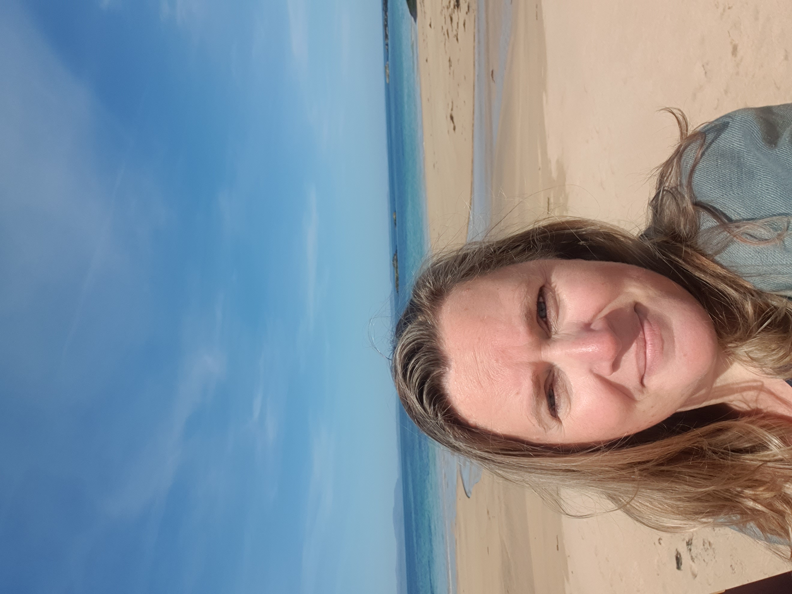 A woman taking a selfie beach background
