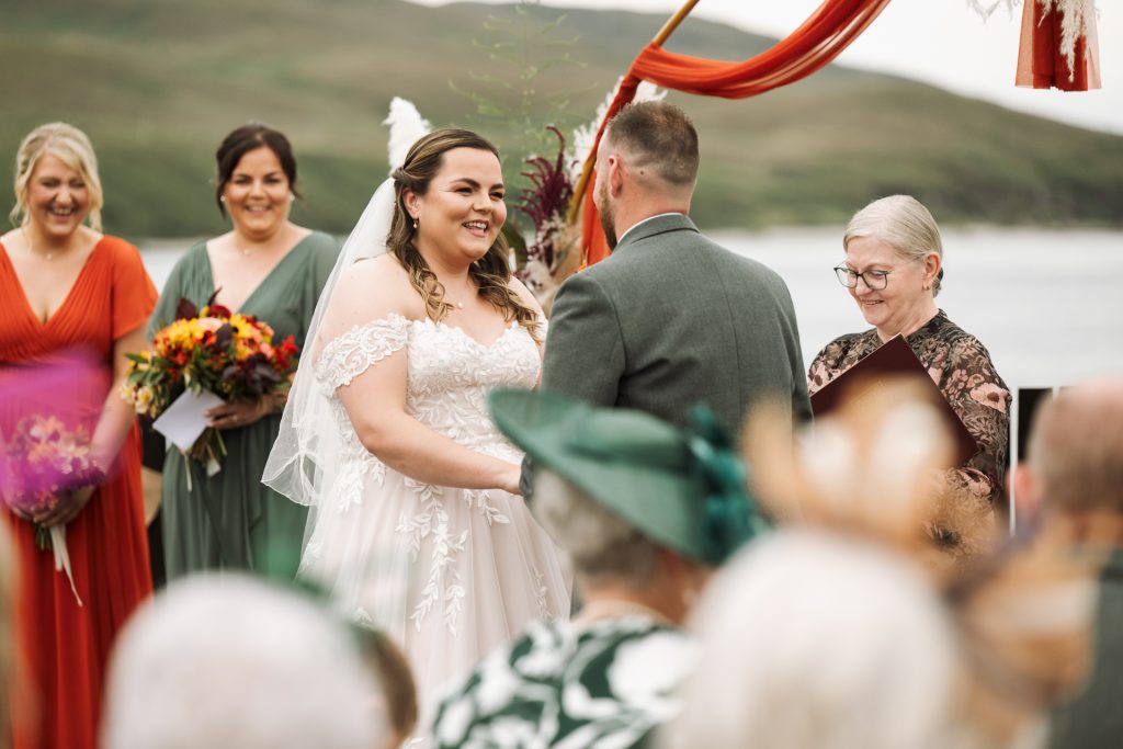 Crowd of people in the centre is a woman in a white dress