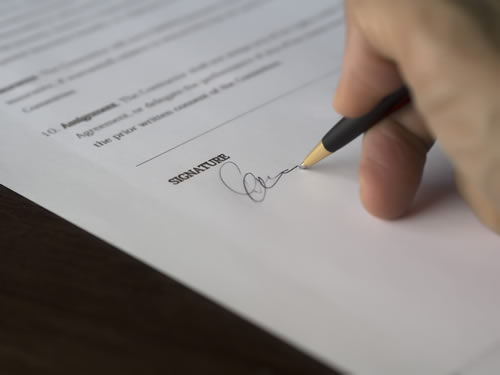 Hand signing paperwork