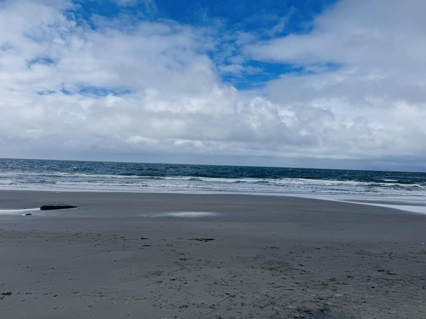 image of a beach with white sand and sunny sky
