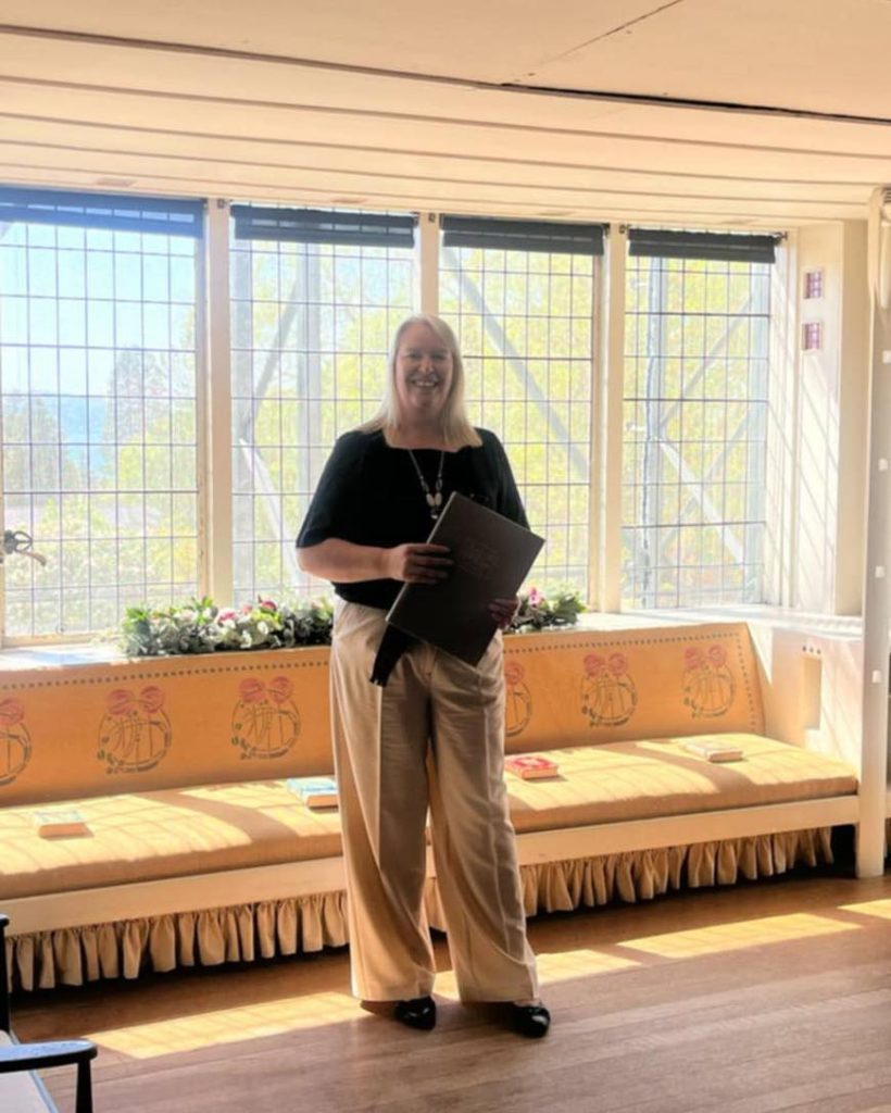 woman standing holding book