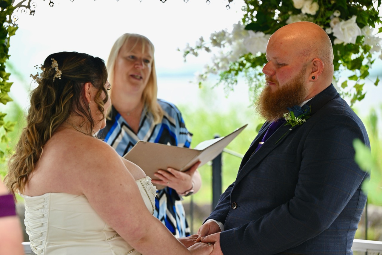 Bride groom and registrar standing