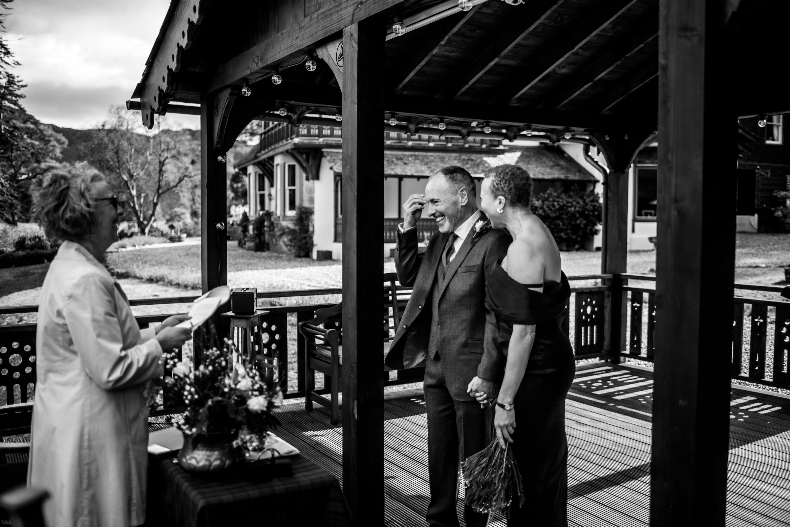 black and white photo under a pavilion 3 people