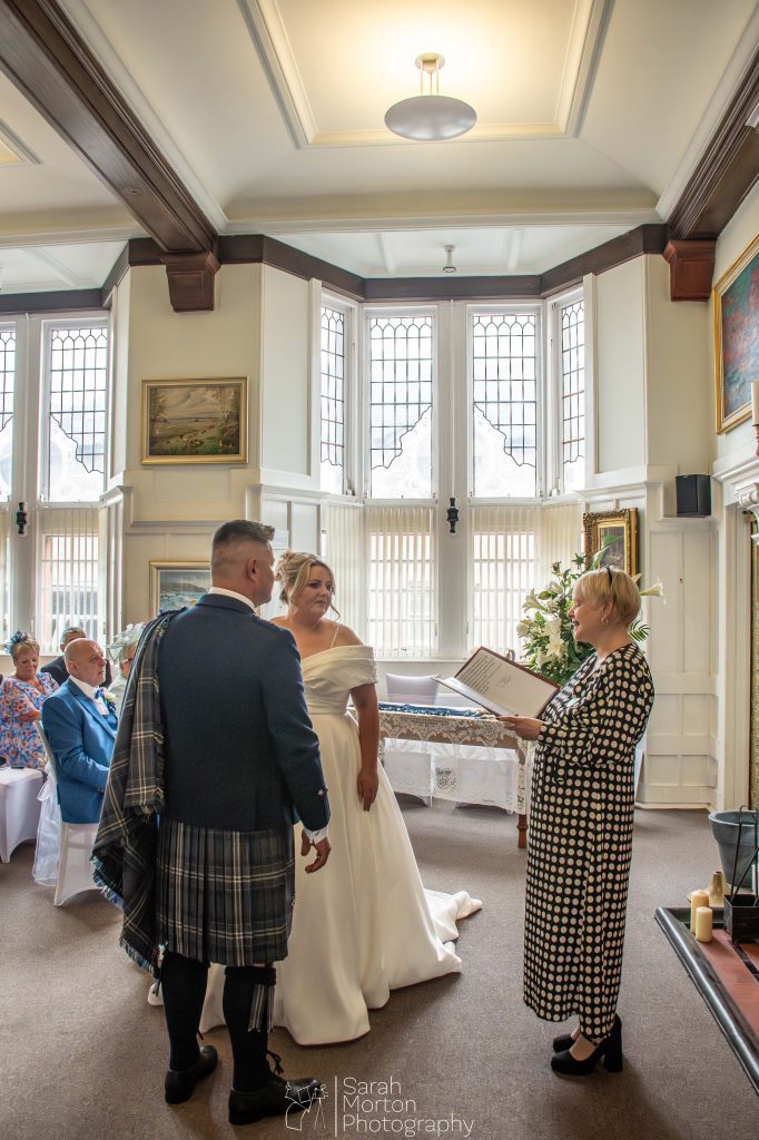 bride and groom in room with registrar