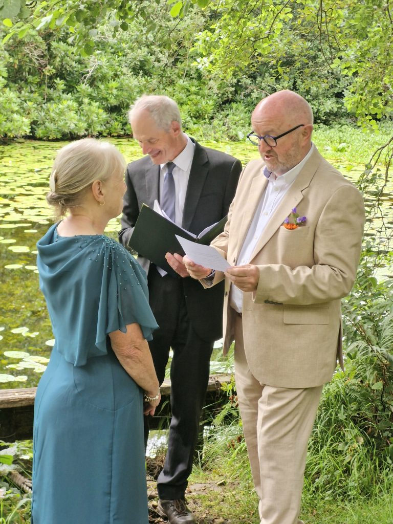 3 people standing with forest behind them