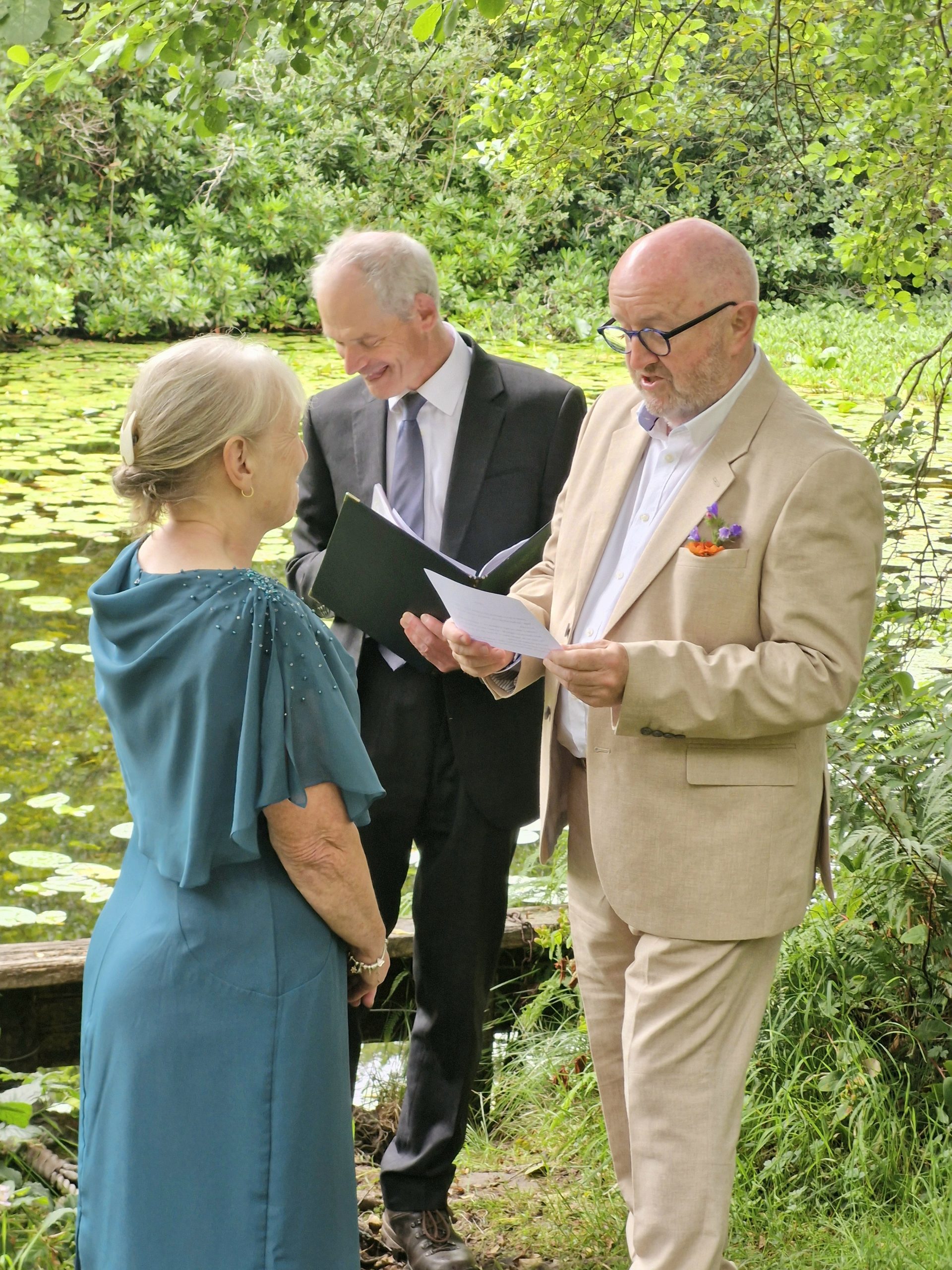3 people standing with forest behind them