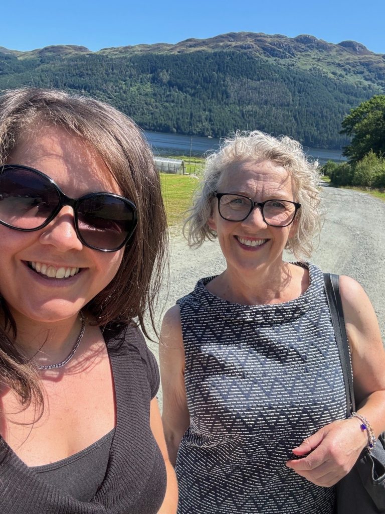 2 woman up close one with sunglasses and the other with normal glasses
