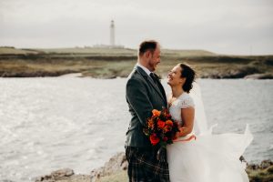 man and woman looking at each other with water in background