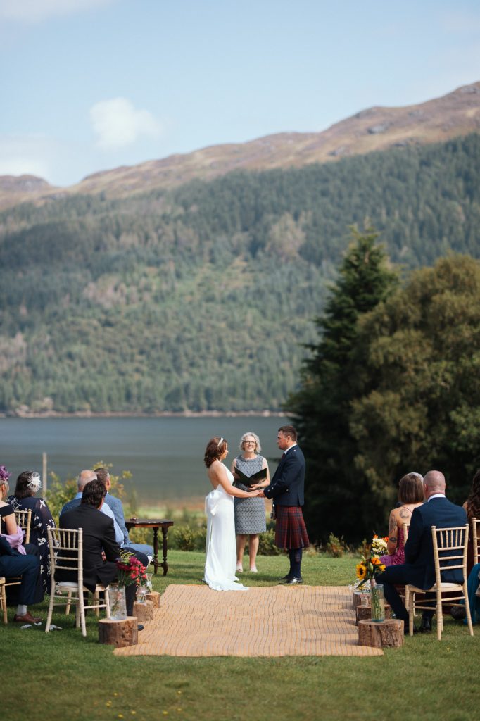 Hills in the background with an aisle and bride groom and registrar