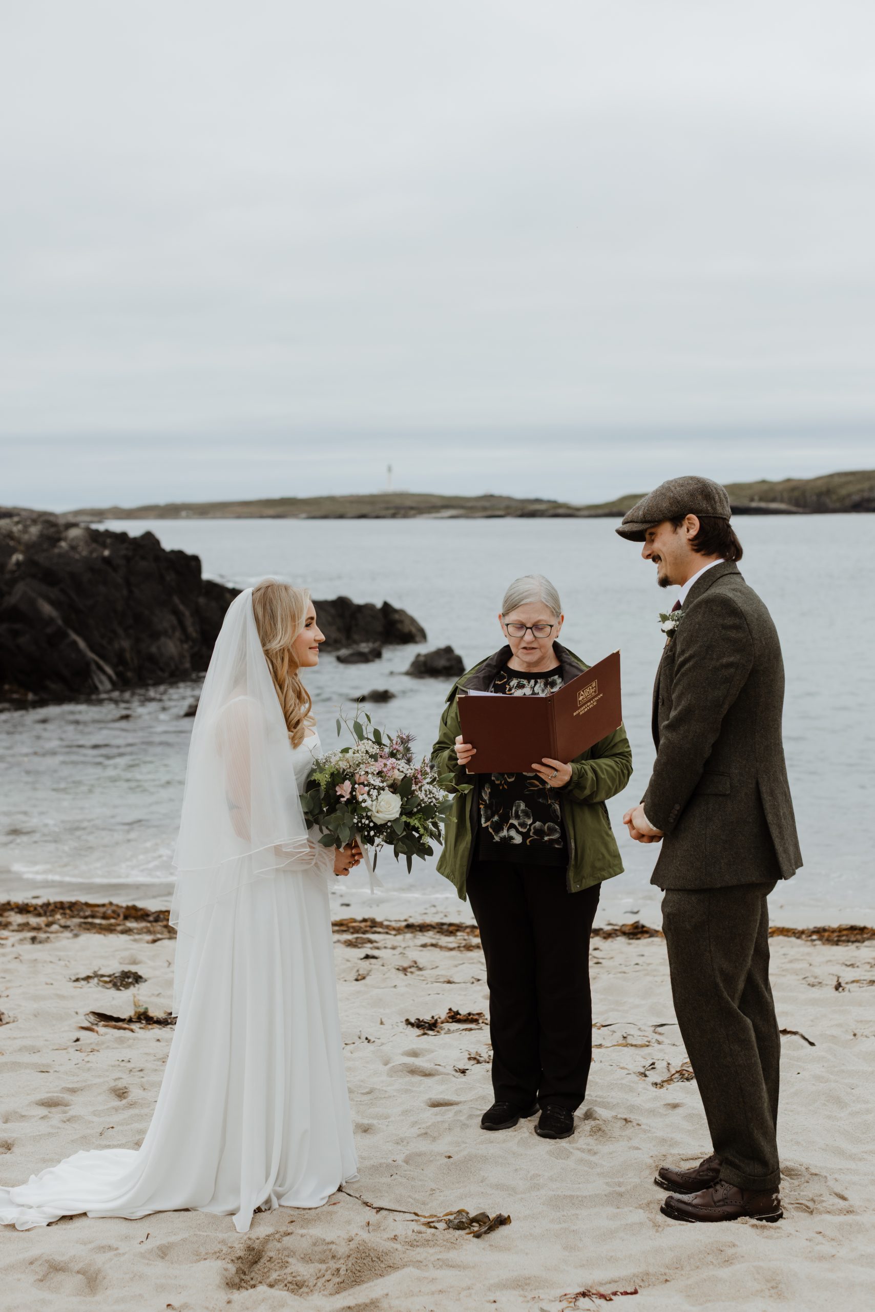 Photo of couple being married on the beach