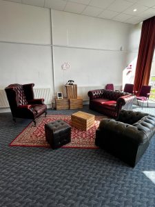 image showing chairs and sofas arranged in a room