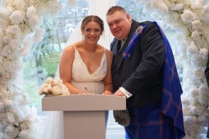 Courtesy of Fyne Photography - Wedding couple signing paperwork