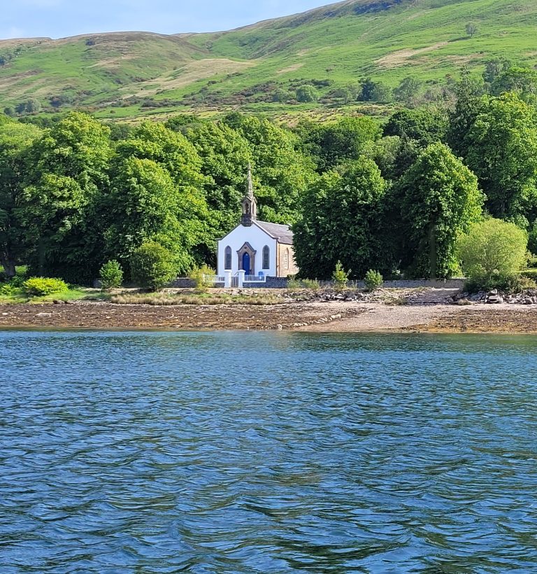 image of a church style building taken from the water