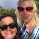 2 woman taking a selfie one with blonde hair the other with dark hair both wearing sunglassess