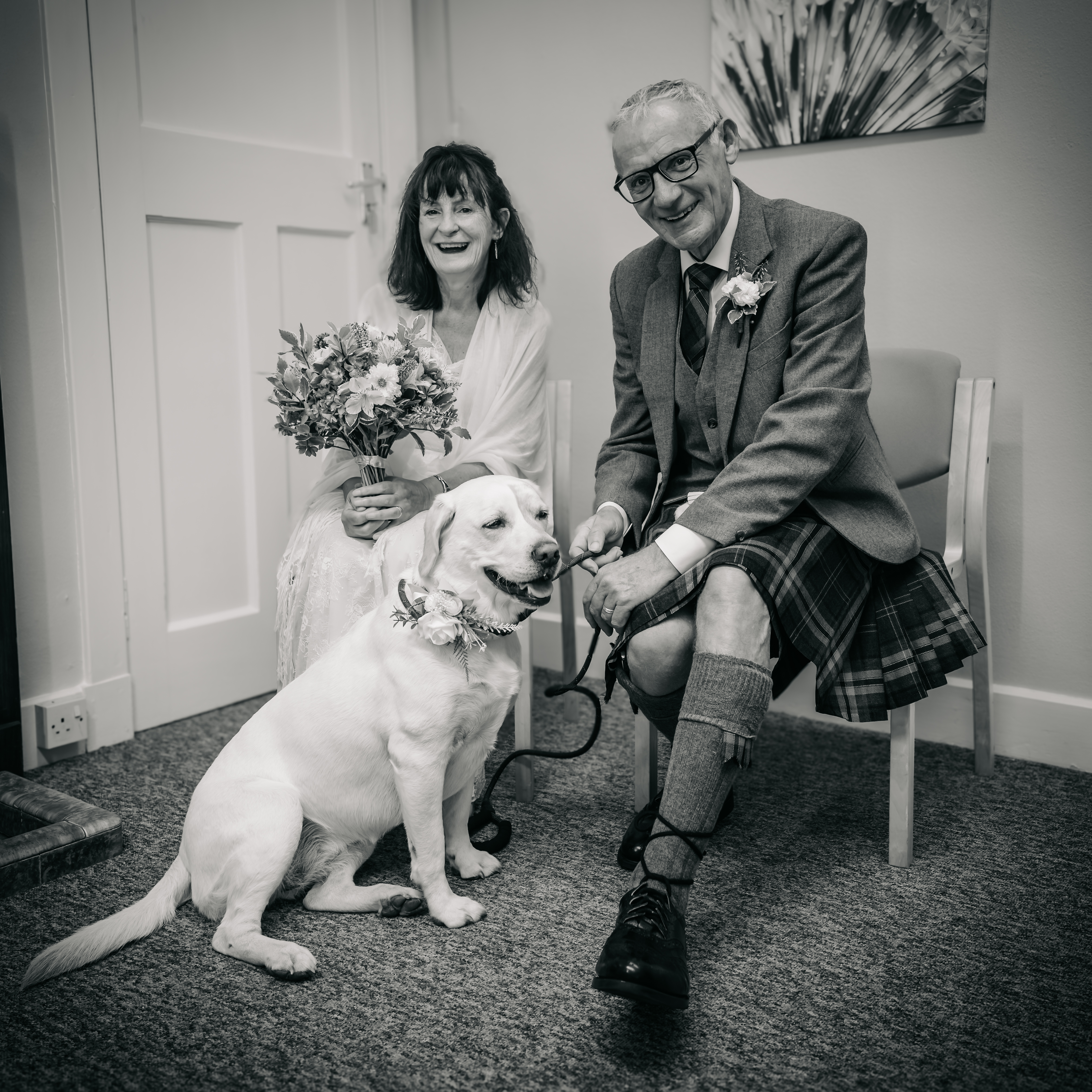 black and white photo man and woman with a lab dog