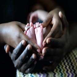 Baby feet clasped in hands