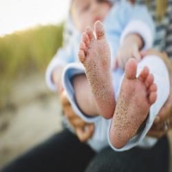 Baby with sandy feet