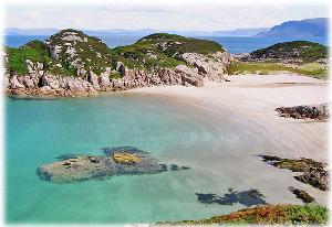 Images shows a bay on Colonsay with turquoise water and a sandy beach 