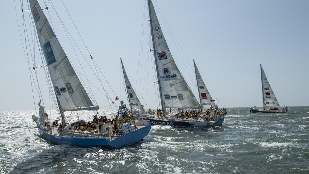 Images shows two racing yachts in the foreground and three in the background