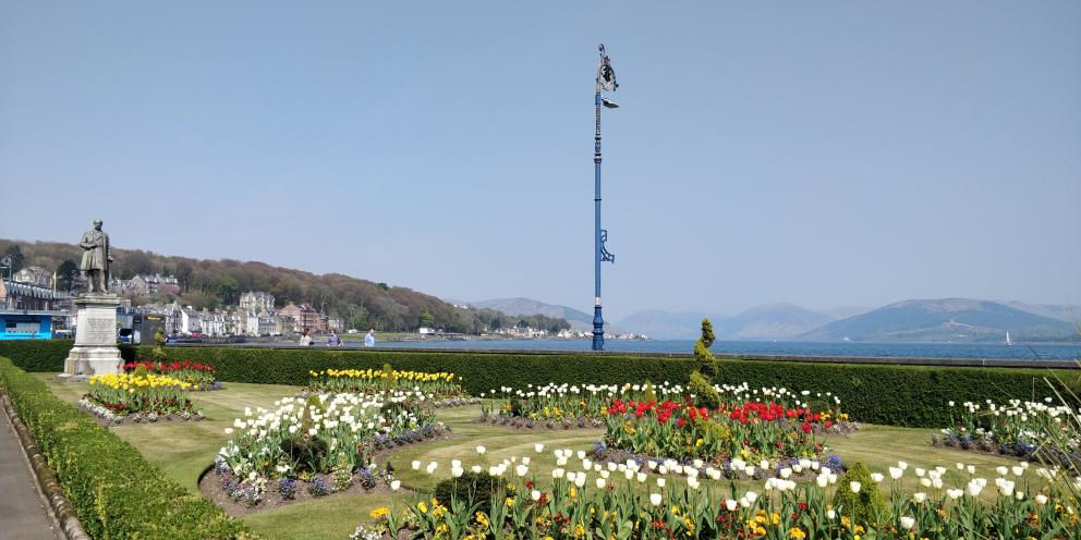 A view of the green at Rothesay with colourful flower beds