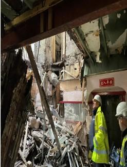 Image shows colleagues from Building Standards looking at the damaged building