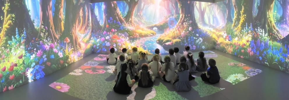 Image shows pupils sat in the immersive classroom with a 360 surround animation