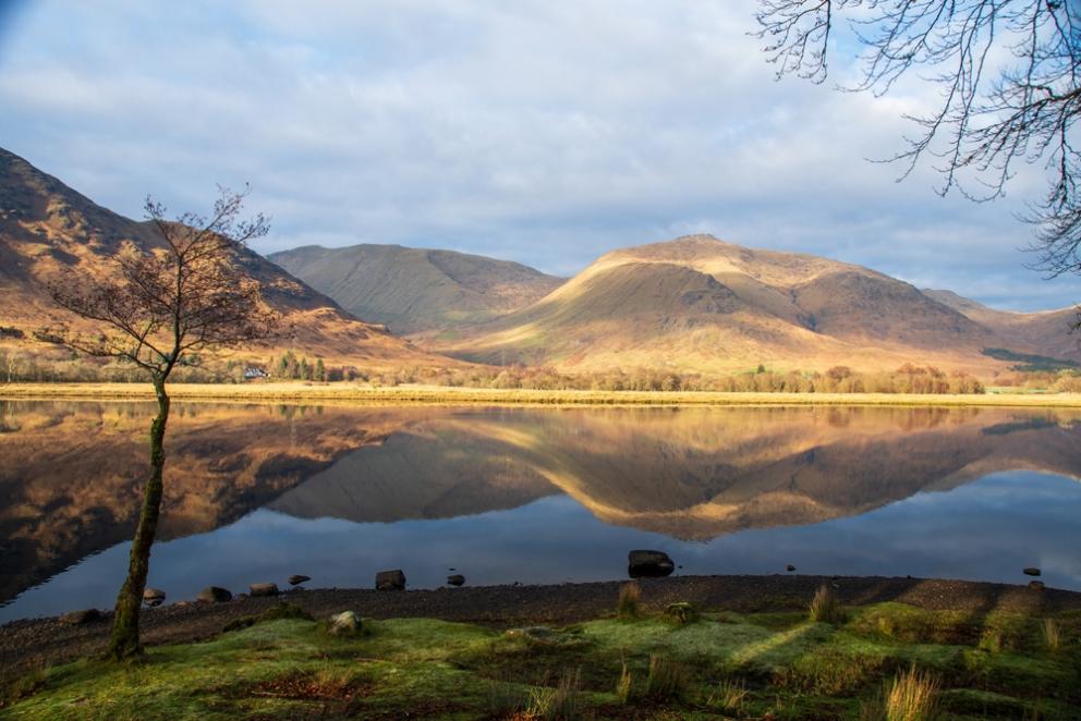 Image shows reflection in the water of the Loch Awe 