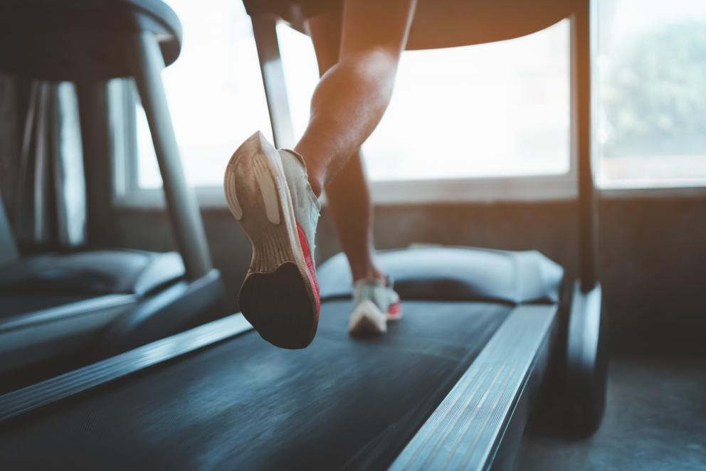 Image shows a woman's feet running on a treadmill
