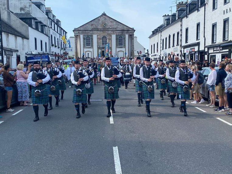 Image shows a pipeband marching down Inveraray's main road