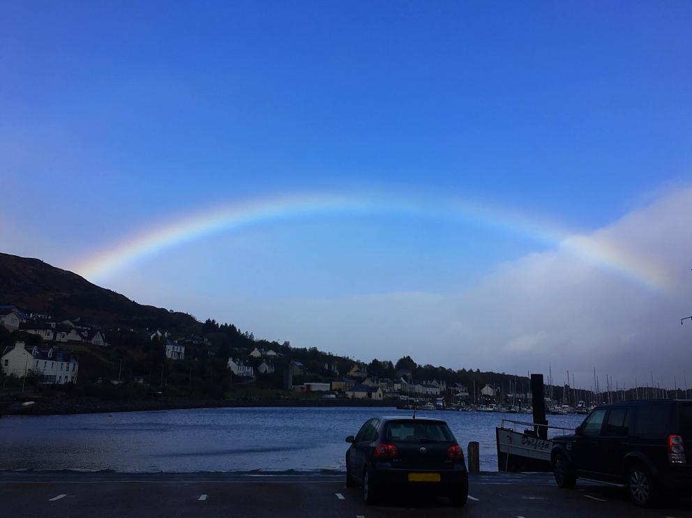 A picture of a rainbow over the town of Tarbert