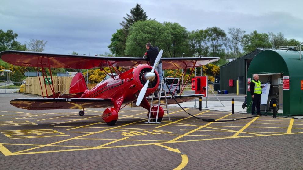 Man filling up plane with fuel