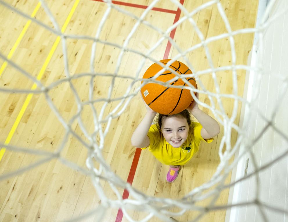 A school pupil playing basketball