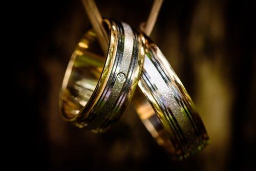 Two gold and silver wedding rings