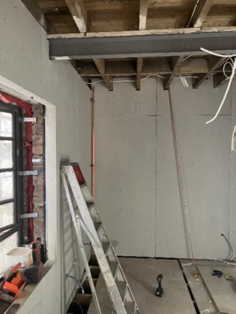 Caretakers House: installation of first fix electrical and insulated plasterboard dry lining to walls to improve thermal resistance or original walls.