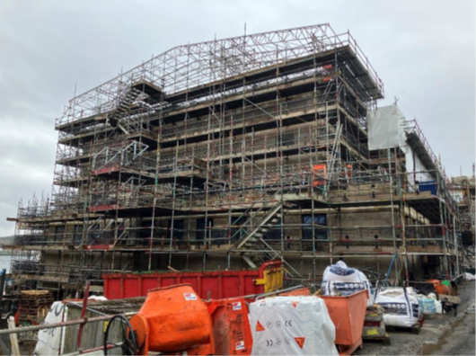 Fly tower section of building covered by scaffolding 