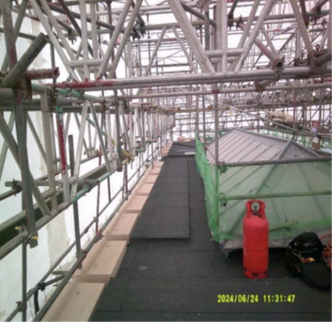 Temporary scaffold and roof trusses insitu. Vapour Control layer of felt insitu.