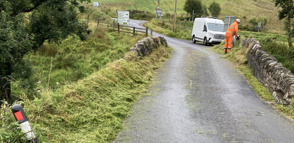 A workman in the background inspects Claonaig Bridge