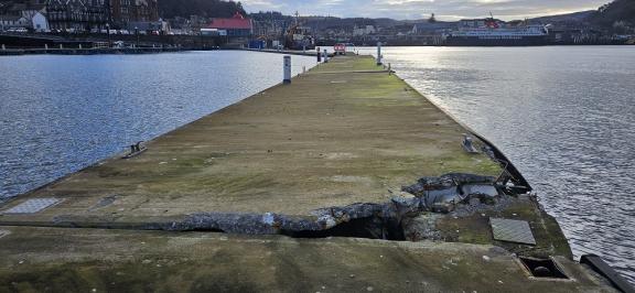 looking towards the North Pier, showing the most damaged unit, with Oban in the background
