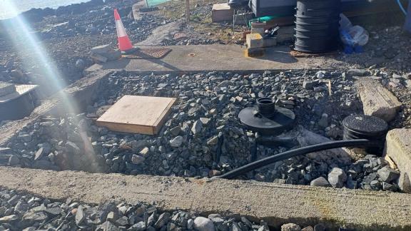 Septic tank installed and covered with stone