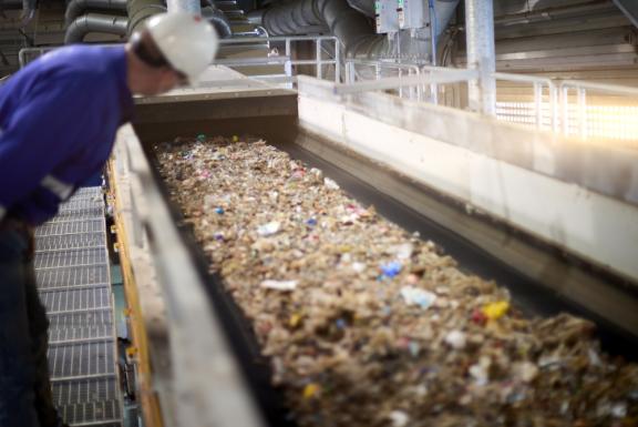 A worker checks the RDF stock on a conveyor line