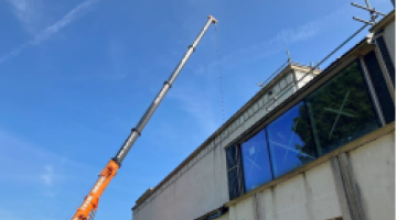 Mobile crane on site for dismantle of the mechanical and engineering plant from the roof