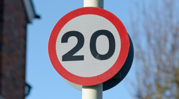 a 20 mph sign on a pole