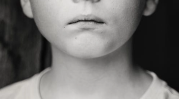 Image shows a child's face in black and white 