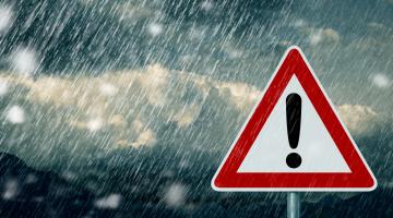 Picture of a warning sign in pouring rain