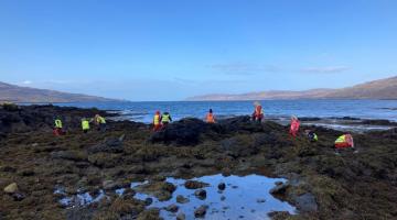 Image shows children from Ulva Primary School enjoying their outdoor classroom on the shoreline