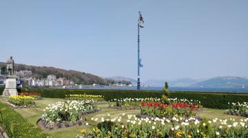 A view of the green at Rothesay with colourful flower beds