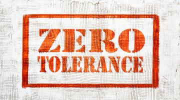 Image shows the words in red zero tolerance outlined with a red border on a white background