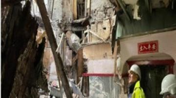 Image shows colleagues from Building Standards looking at the damaged building