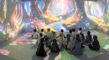 Image shows pupils sat in the immersive classroom with a 360 surround animation